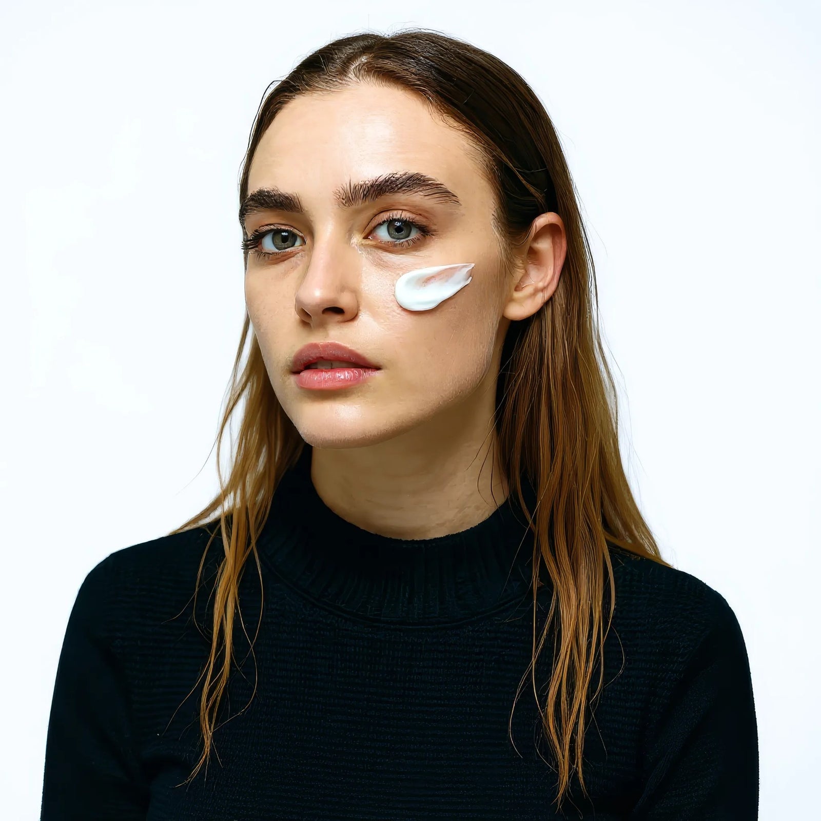 Model with cream on cheek